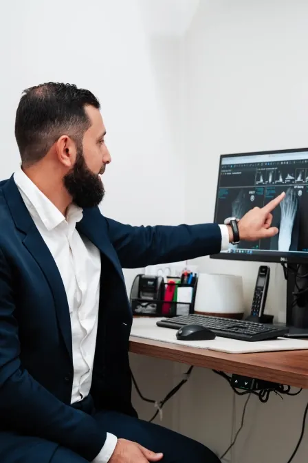 Dr Abdel Kak pointing out a foot X-ray on screen.